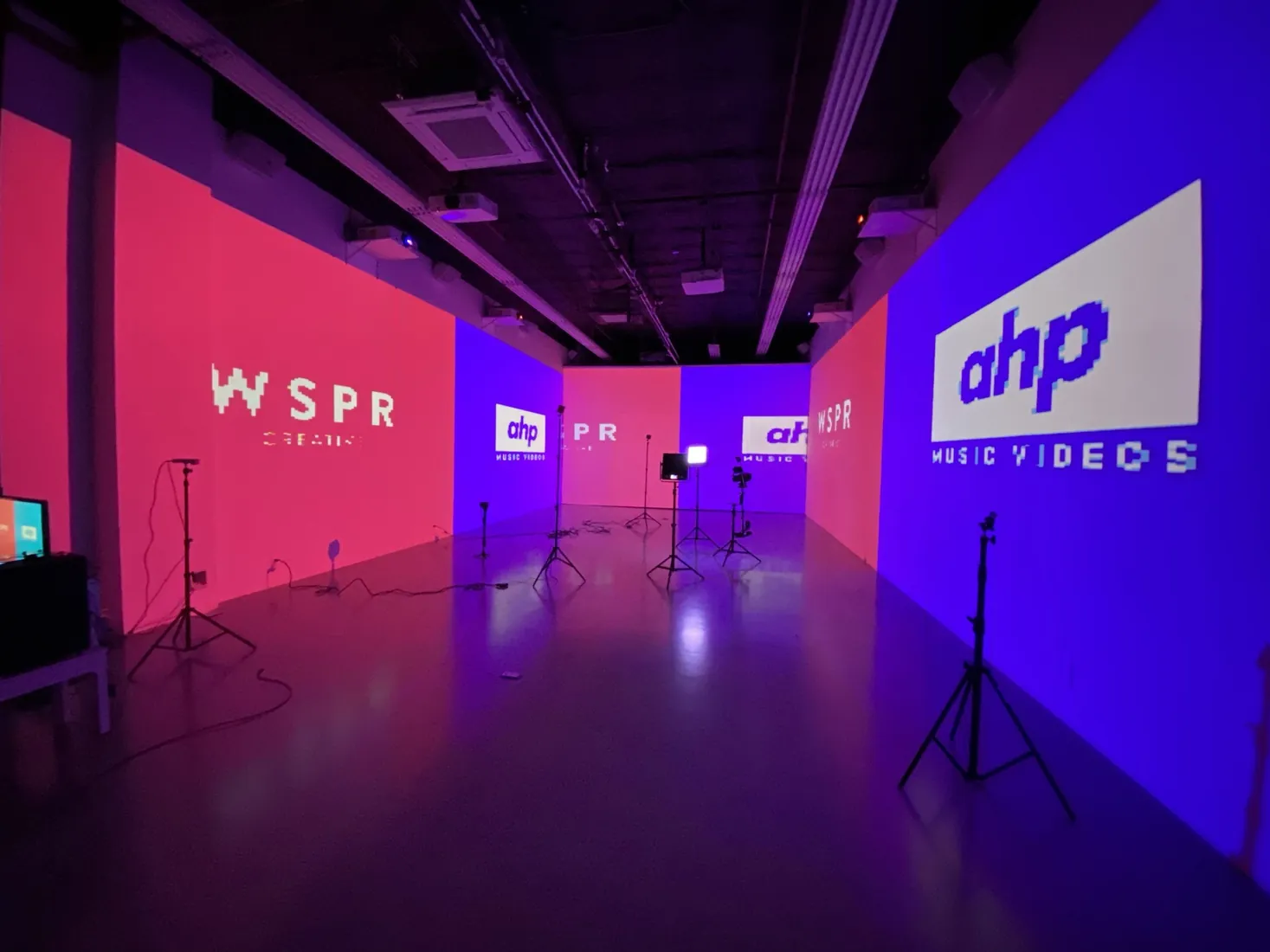 The AHP studio lit pink and purple, with the AHP and WSPR logos on the walls.