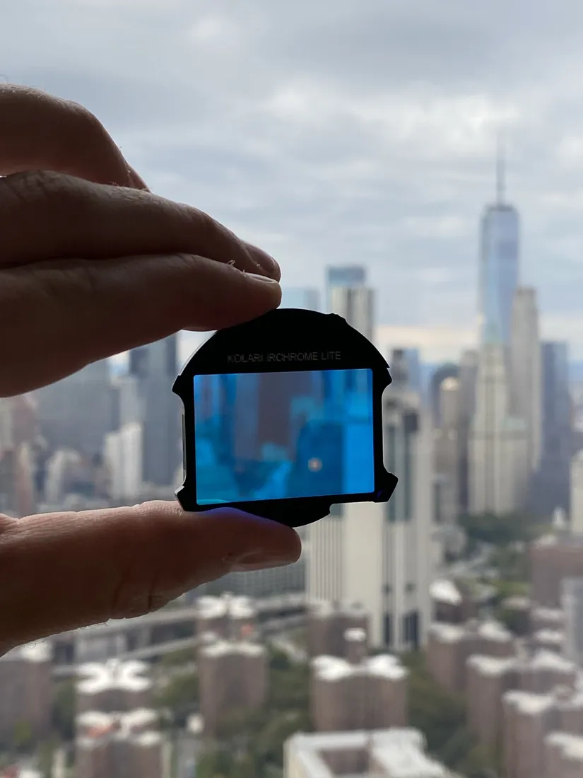 Holding a piece of camera gear up against the Manhattan skyline.