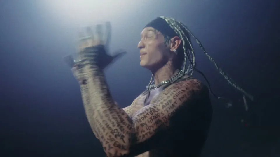 Music video still filmed at WRECK’D Productions in Tinton Falls, NJ: Uncured’s singer, braids and words written across the skin, in “Manifesto”